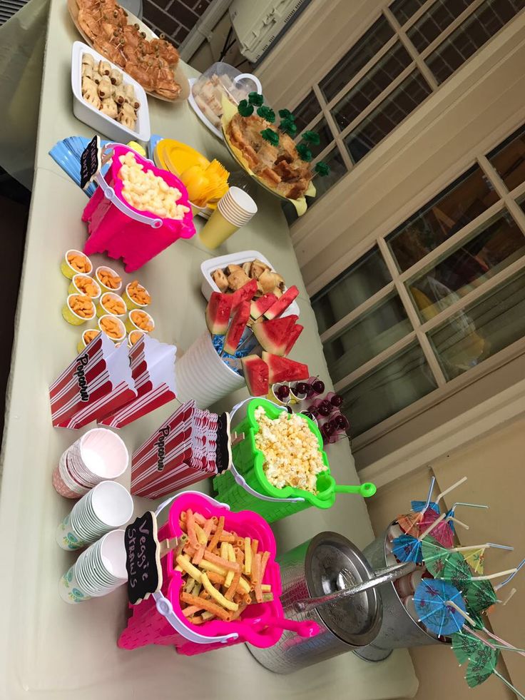 a long table filled with different types of food and drinks on it's sides