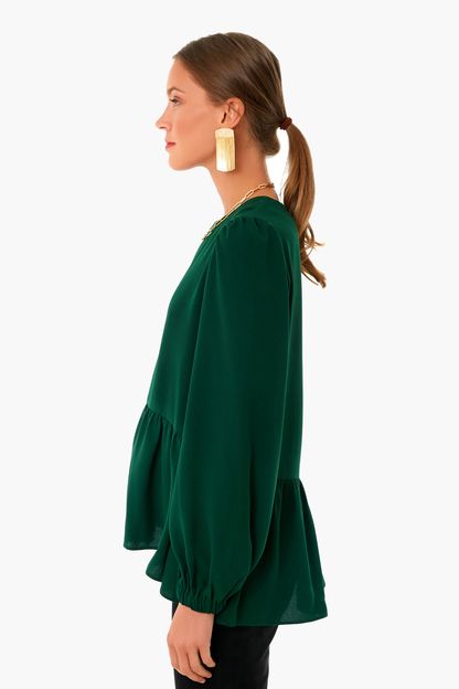 Flowy and flattering, the Carlota Peplum Blouse is a wardrobe must-have. In a rich hunter green hue, this top features cuffed puff sleeves, keyhole button back closure, high-low silhouette, and a peplum hem detail. Pair with denim and a change of accessories for a look that will take you from desk to drinks!

Crew neckline
Cuffed sleeves
Slightly puffed sleeves
High-low
Peplum detail100% Polyester
Care: Hand wash cold Brunch Blouse With Blouson Bishop Sleeves, Bishop Sleeve Blouse With Blouson Sleeves For Brunch, Blouson Bishop Sleeve Blouse For Brunch, Blouse With Blouson Bishop Sleeves For Brunch, Chic Peasant Top With Blouson Bishop Sleeves, Chic Peasant Top With Bishop Blouson Sleeves, Flowy Blouse With Blouson Balloon Sleeves, Chic Fall Peplum Top With Puff Sleeves, Workwear Blouse With Ruffle Hem And Puff Sleeves