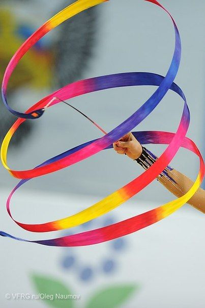 a hand holding a colorful streamer in the air