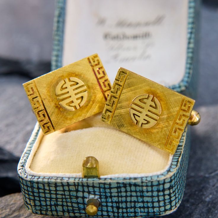 These bold cufflinks have a rectangular face with a symbol reminiscent of the Chinese character for "long life." The face has a Florentine finish with a Greek key pattern on each end of the rectangle. They are crafted in 14k yellow gold with a stunning patina and are finished with a toggle closure. Antique Engagement Rings Sapphire, Rectangular Face, Estate Jewelry Rings, Wedding Ring Diamond Band, Brand Presentation, Greek Key Pattern, Gold Cufflinks, Antique Engagement Rings, Tiffany And Co