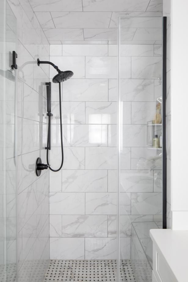 a walk in shower sitting next to a white counter top