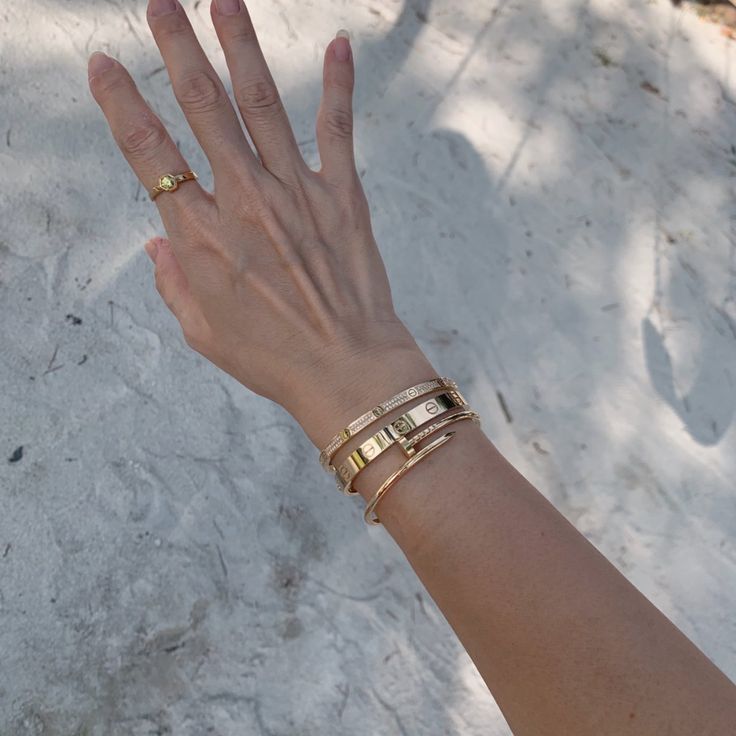 Cartier Love Bracelet Stack Ideas, Cartier Wrist Stack, Gold Bangle Stacking Ideas, Stacking Bracelets With Watch, Gold Bracelet Layering, How To Layer Bracelets With A Watch, Wrist Jewelry Stack, Cartier Love Cuff Bracelet, Bracelet Layering Ideas Gold