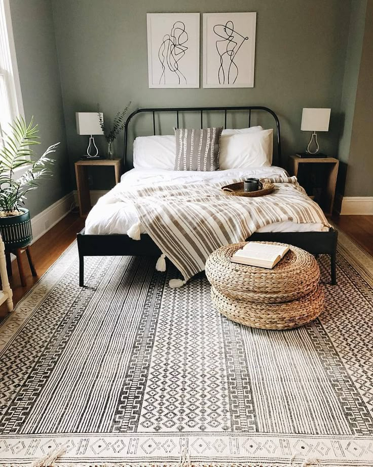 a bed sitting on top of a rug next to a window