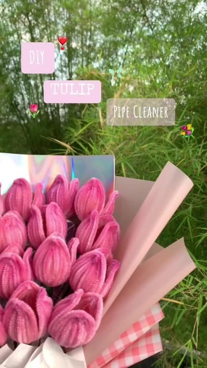 a bouquet of pink flowers sitting on top of a lush green field