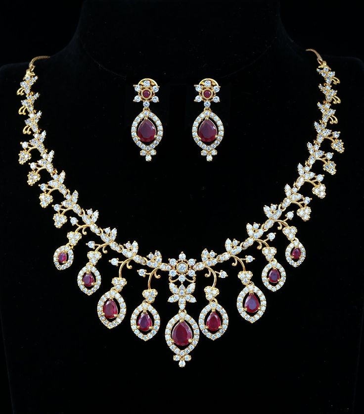 This exquisite Mothers Day Gift necklace showcases a charming South Indian-style gold floral design, featuring ruby and emerald stones. Intricately handcrafted, this statement jewelry will add a beautiful touch to wedding or special occasion outfit. Emerald And Ruby Necklace, Occasion Outfit, Indian Wedding Jewelry, Special Occasion Outfits, Kundan Necklaces, Cz Jewelry, Floral Necklace, Emerald Stone, American Diamond