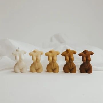 four small figurines sitting in the middle of a white bedding sheet,