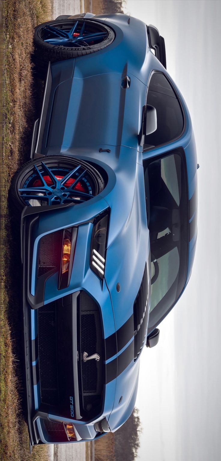 the rear end of a blue sports car