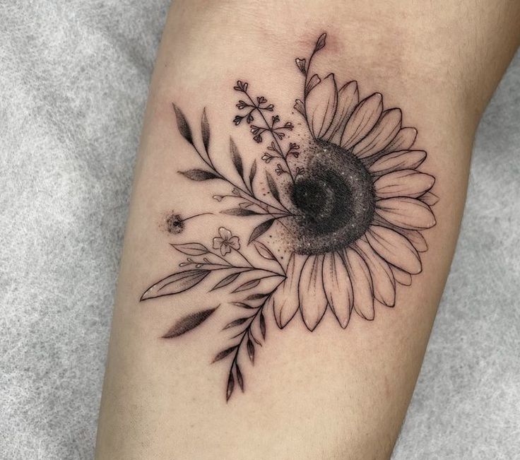 a black and white photo of a sunflower tattoo