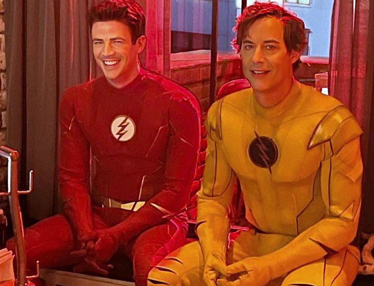 two men dressed as the flash sitting next to each other