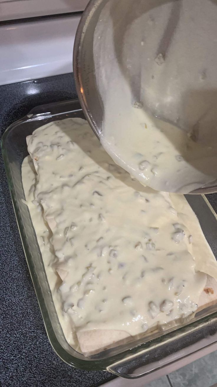 a pan filled with food sitting on top of a stove