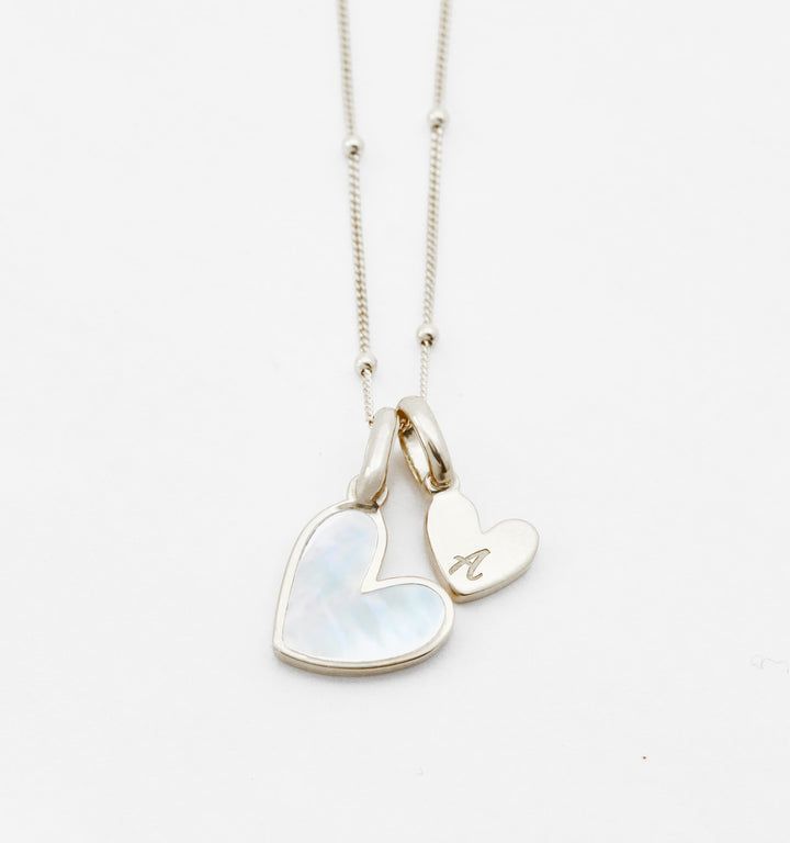 Mother of Pearl Initial Necklace – Rellery. For Valentine’s Day Dainty Sterling Silver Charm Necklace With Heart Beads, Heart-shaped Initials Charm Necklace, Sterling Silver Heart Necklace With Initials, Sterling Silver Pearl Charm Necklace, Everyday Sterling Silver Necklace With Pearl Charm, Everyday Heart Bead Charm Necklaces With Heart Pendant, White Sterling Silver Charm Necklace With Heart Charm, Everyday Heart Pendant Charm Necklace, Everyday Engraved Heart Necklace