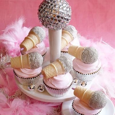 cupcakes and ice cream cones are arranged in a cone with pink icing