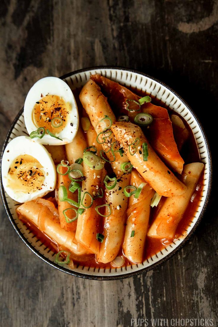 a bowl filled with carrots and hard boiled eggs