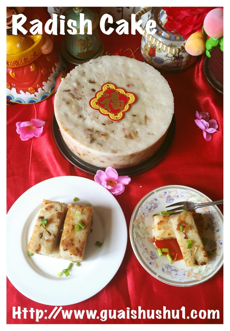 there is a cake and two plates on the table with food in front of it