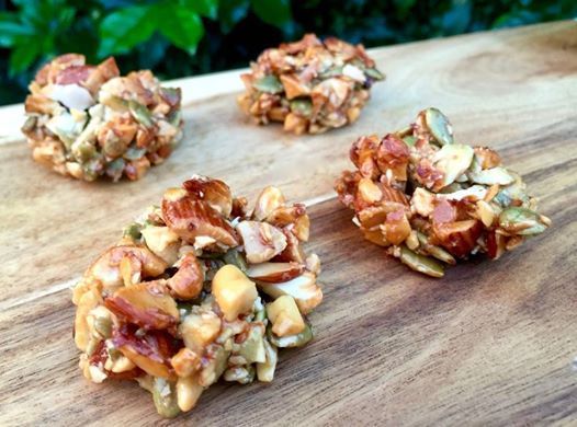 four pieces of food sitting on top of a wooden cutting board