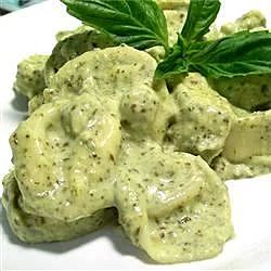 some food is sitting on a white plate with green leafy garnishes