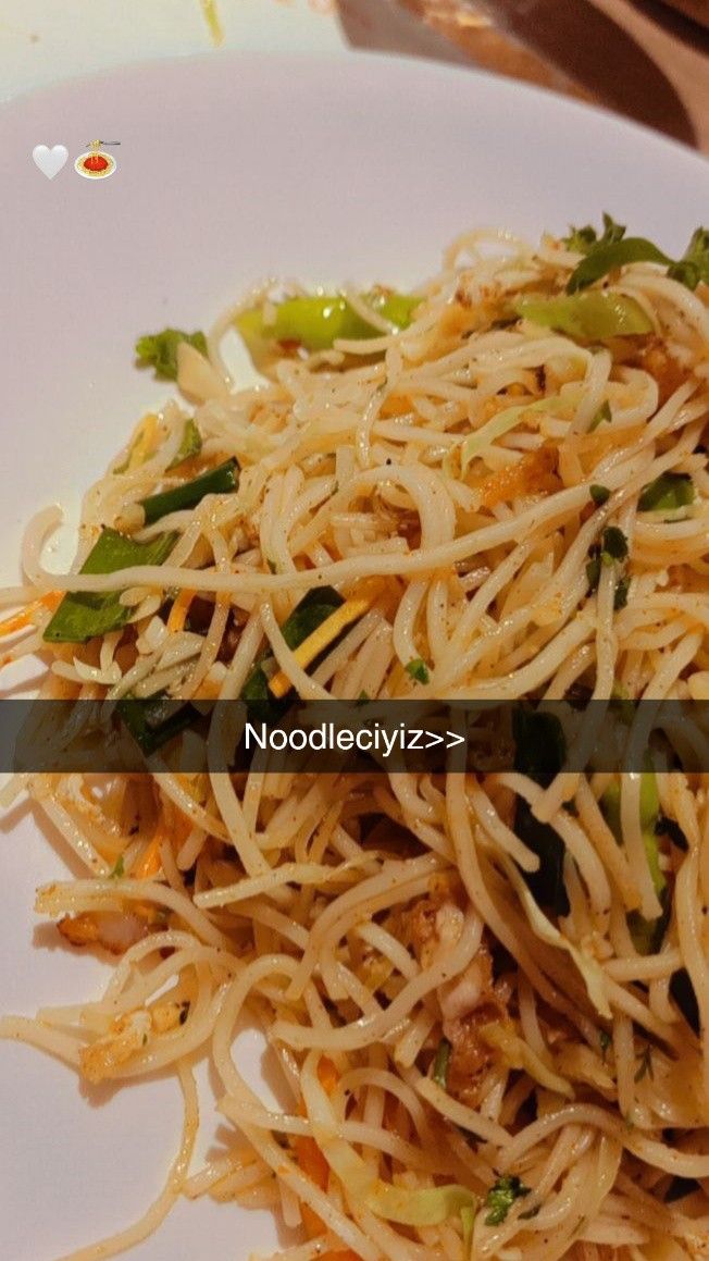 a white plate topped with noodles and veggies