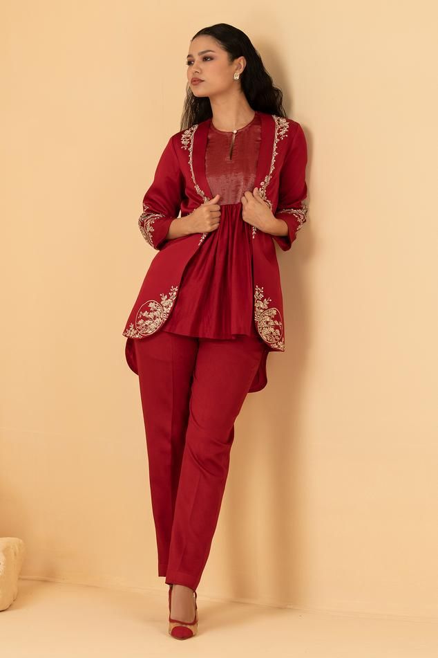 Red chanderi jacket with zari, sequin, pearl embroidery in floral placement pattern. Paired with sleeveless top and pant.
Components: 3
Pattern: Embroidery
Type Of Work: Zari, sequin, pearl, floral
Neckline: Jacket: Open, Top: Keyhole
Sleeve Type: Three quarter
Fabric: Chanderi, Modal Satin
Color: Red
Other Details: 
Asymmetric hem
Attached lining
Length:
Jacket: 30 inches
Top: 29 inches
Sleeves: 18 inches
Pant: 40 inches
Weight: 2 kgs
Occasion: Party - Aza Fashions Embroidered Chanderi Pant Set, Chanderi Pant Set With Floral Embroidery, Designer Festive Pant Set With Floral Embroidery, Elegant Chanderi Nehru Jacket With Traditional Drape, Designer Anarkali Pant Set With Floral Embroidery, Chanderi Pant Set For Diwali, Elegant Nehru Jacket With Traditional Drape In Chanderi, Bollywood Style Floral Embroidery Pant Set For Eid, Bollywood Pant Set With Floral Embroidery For Eid