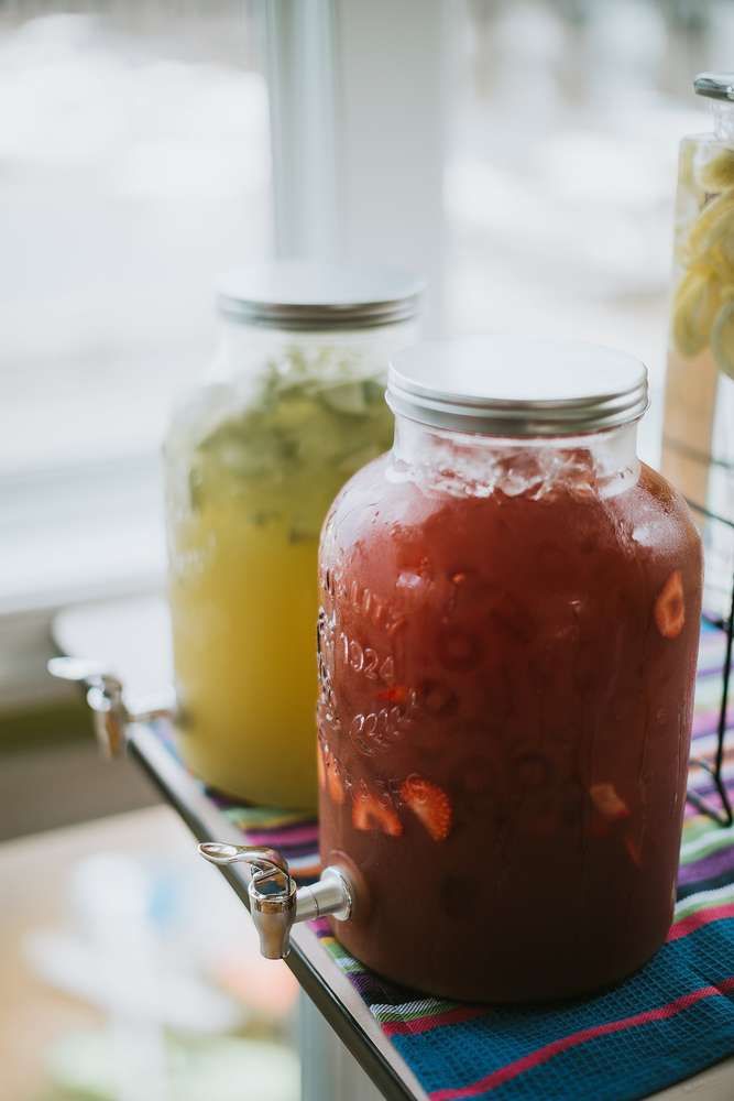 two mason jars filled with liquid sitting on top of a table