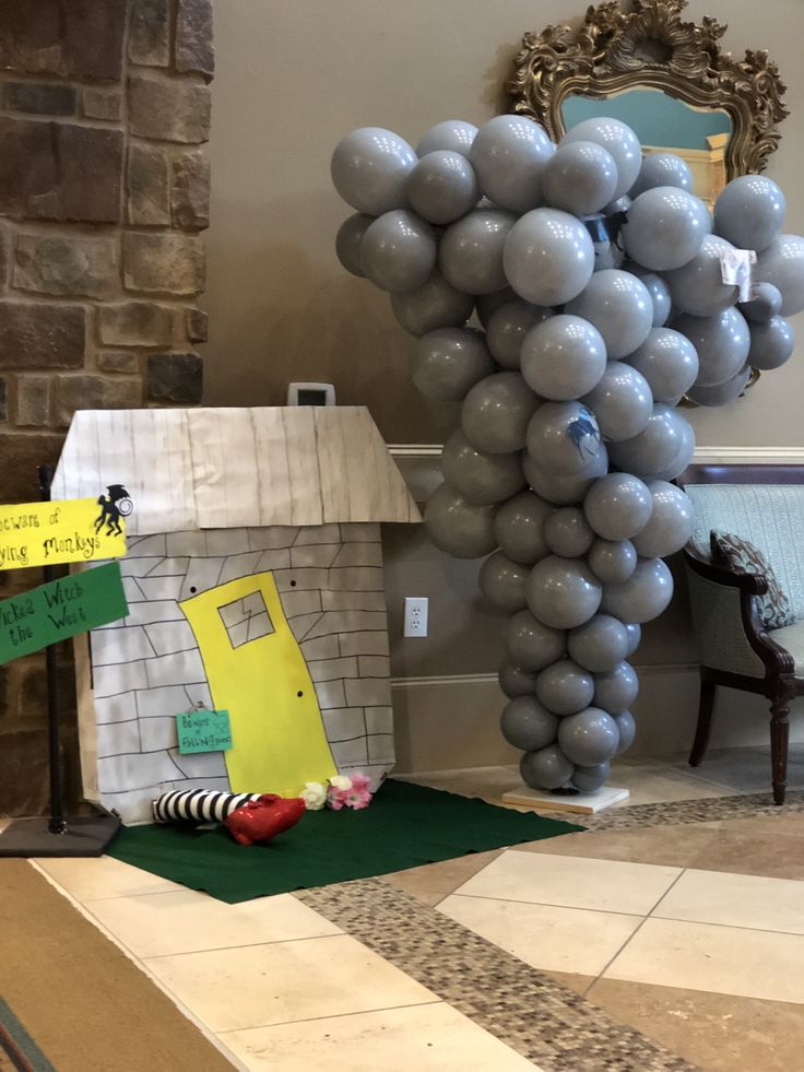 a house made out of balloons sitting on top of a floor