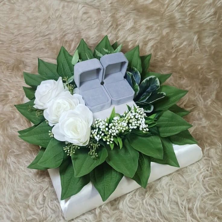 an arrangement of flowers and candles on a furnishing floor in front of a rug