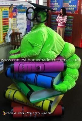 a person in a costume sitting on top of books