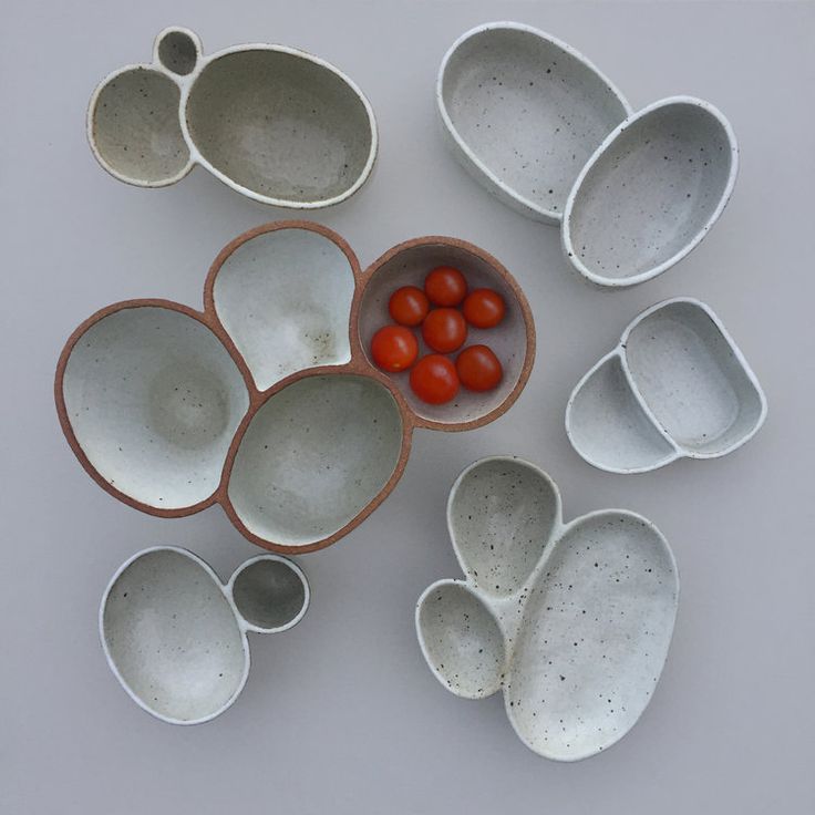 several bowls and spoons with tomatoes in them