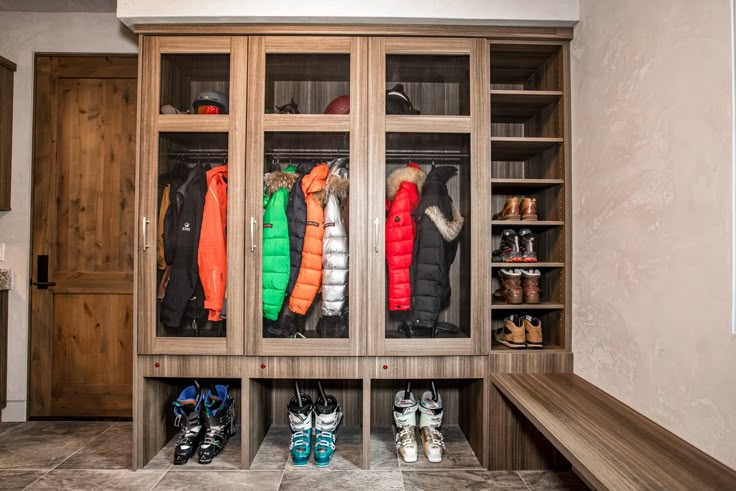 a closet with several coats and snow shoes in it