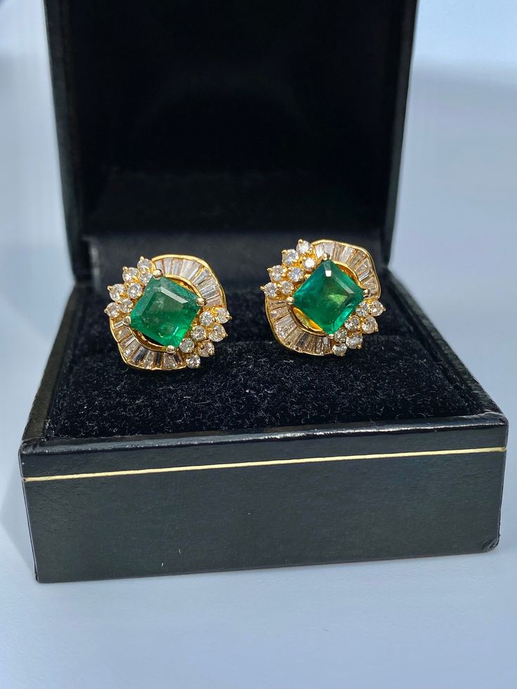 "Pacific Jewelry Presents, Vintage natural Colombian Emeralds, featuring two exquisite square cut Emeralds weighing approx. 1.70 carats (total) and adorned with lively colorless natural diamonds. Diamonds are an assortment of baguette and round cut, approx. 1.35 carats (total). These beautiful earrings are mounted in 18k yellow gold, and have a safe push back closure made in 14k gold for extra strength and durability. The Emeralds are of the highest quality and are untreated. The deep \"muzo gre Emerald Diamond Earrings For Formal Events, Formal Emerald Diamond Earrings, Luxury Emerald Cut Diamond Earrings For Formal Occasions, Luxury Emerald-cut Diamond Earrings For Formal Occasions, Gia Certified Emerald Earrings For Formal Occasions, Gia Certified Luxury Yellow Gold Earrings, Luxury Gia Certified Yellow Gold Earrings, Luxury Gia Certified Yellow Gold Diamond Earrings, Formal Baguette Cut Emerald Earrings