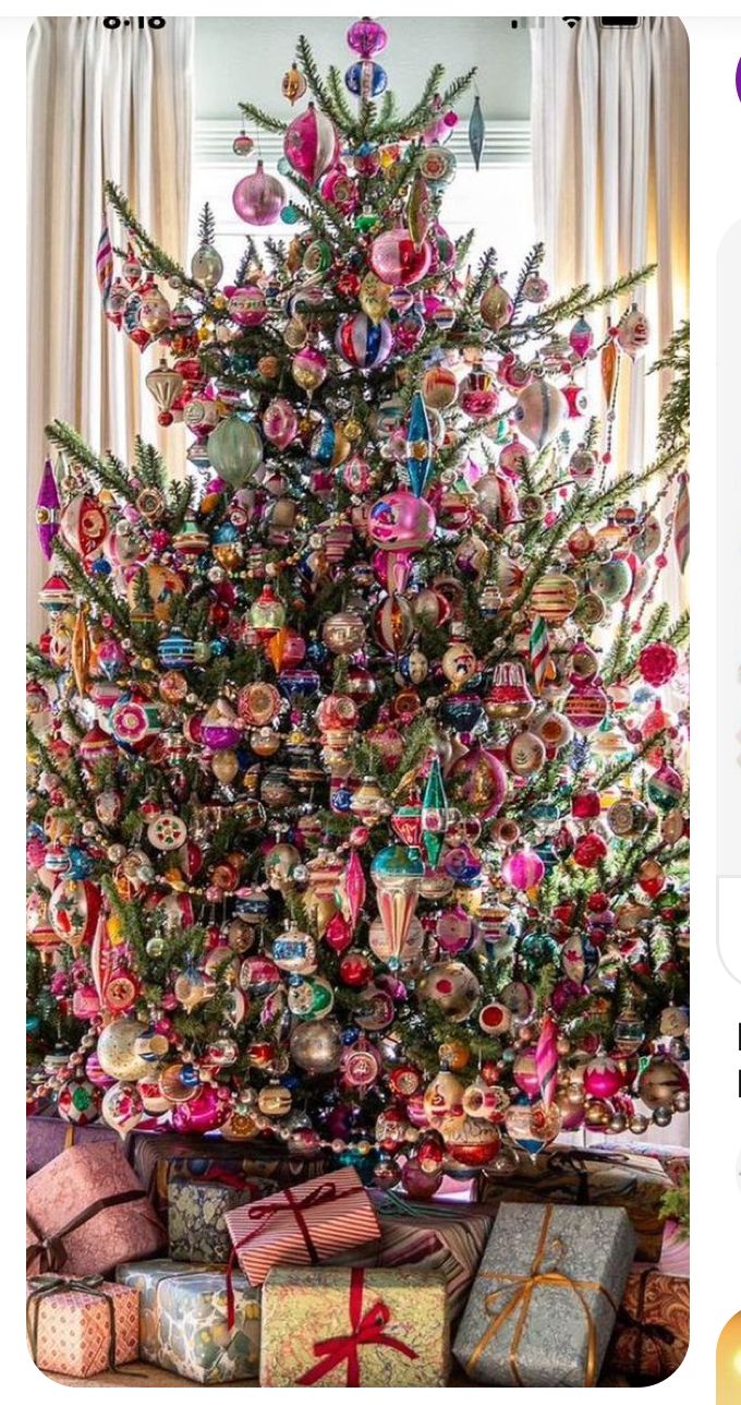 a christmas tree is decorated with ornaments and presents