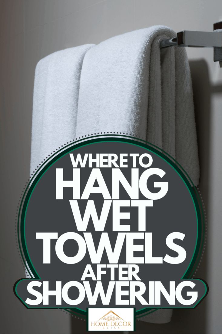 there is a towel rack with towels hanging on it and the words where to hang wet towels after showering