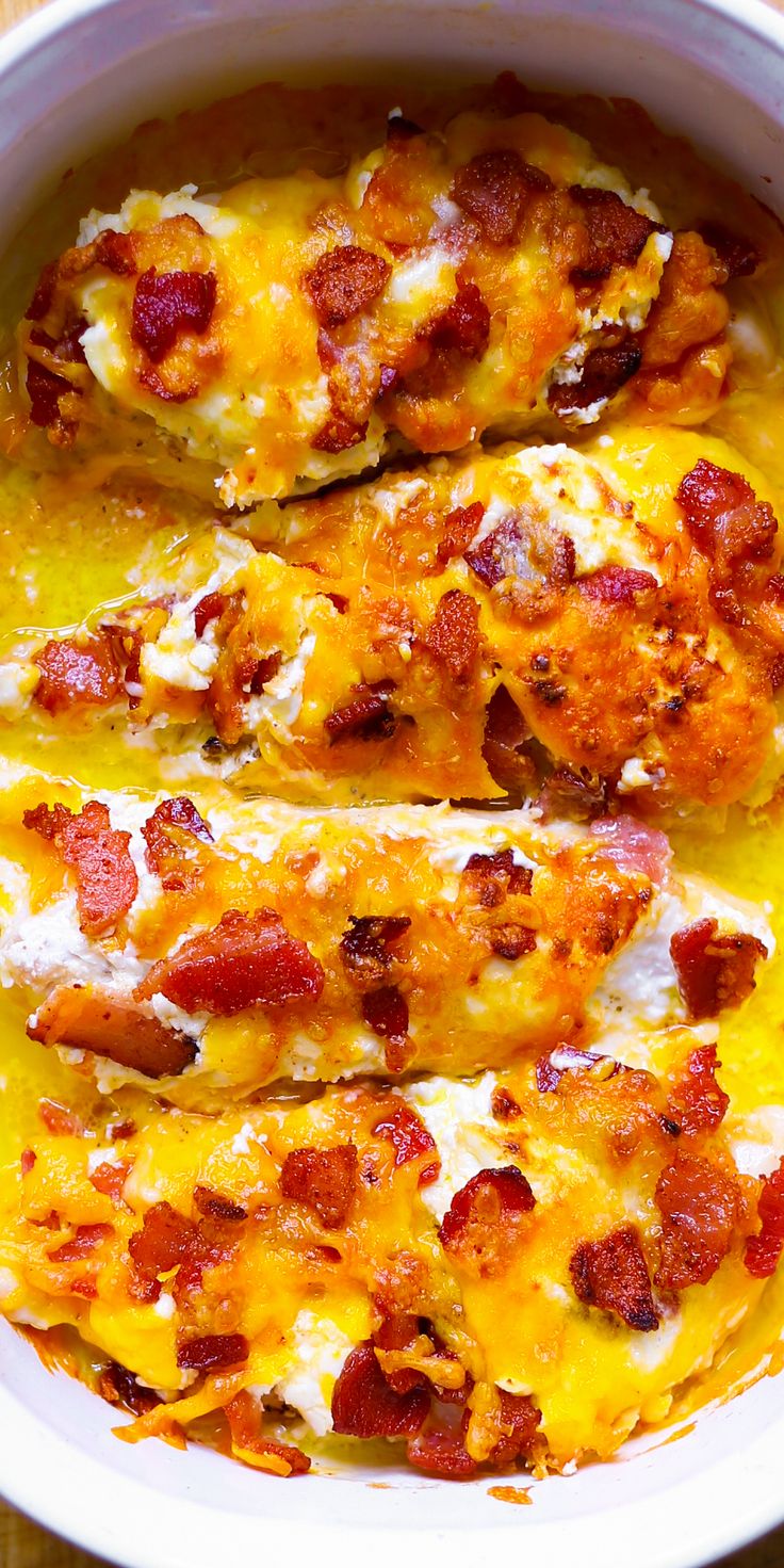 a casserole dish with chicken, cheese and bacon in it on a white plate