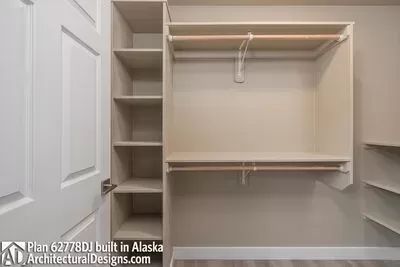 an empty walk in closet with white walls