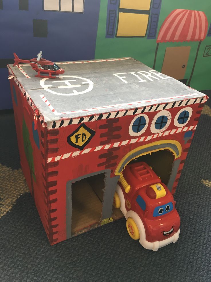 a toy firetruck is in the shape of a garage