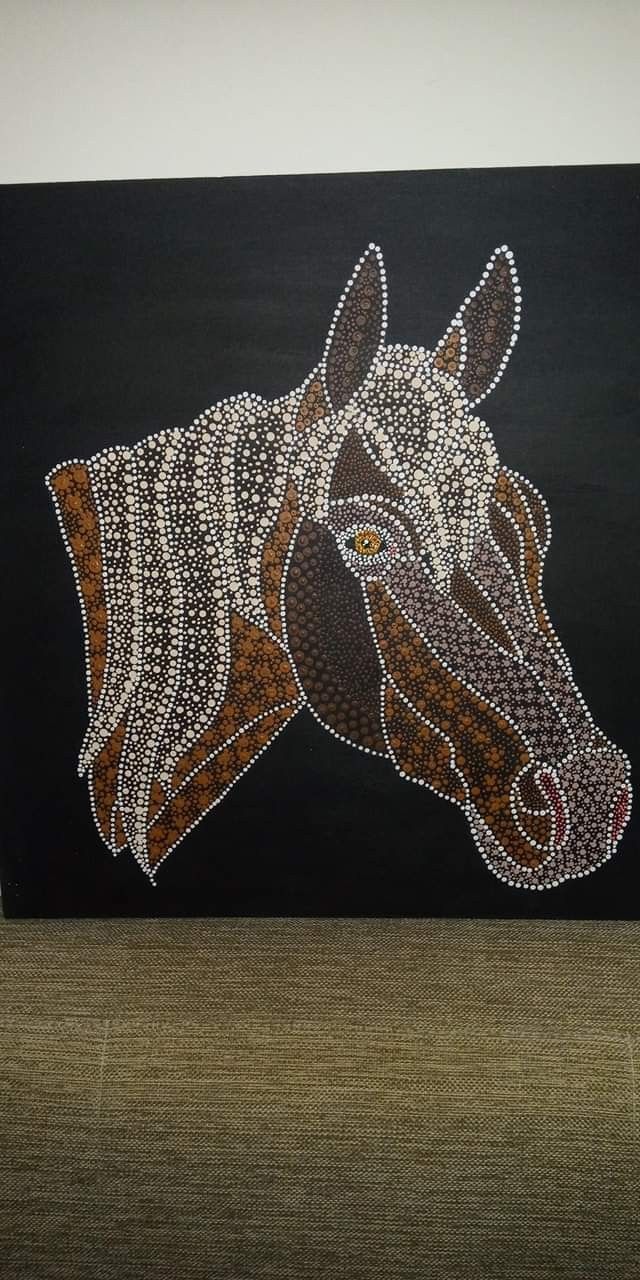 a painting of a horse on a black background with white and brown dots in the head