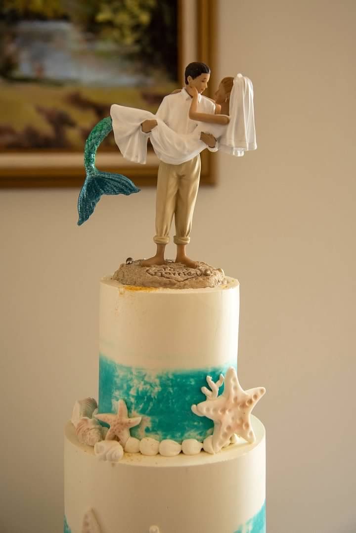 a wedding cake with a bride and groom figurine on top