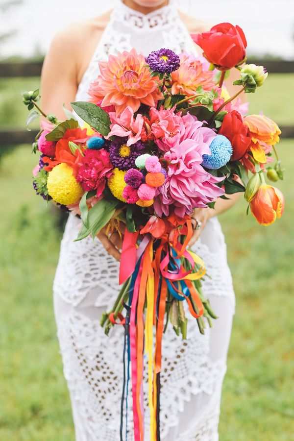 a woman holding a bouquet of flowers in her hands