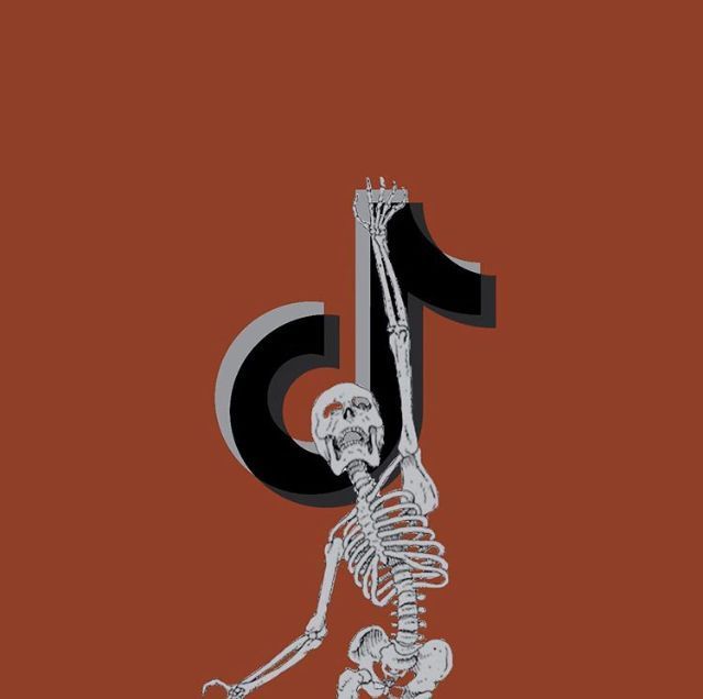 a skeleton is holding the number thirteen in its hand and it appears to be falling down