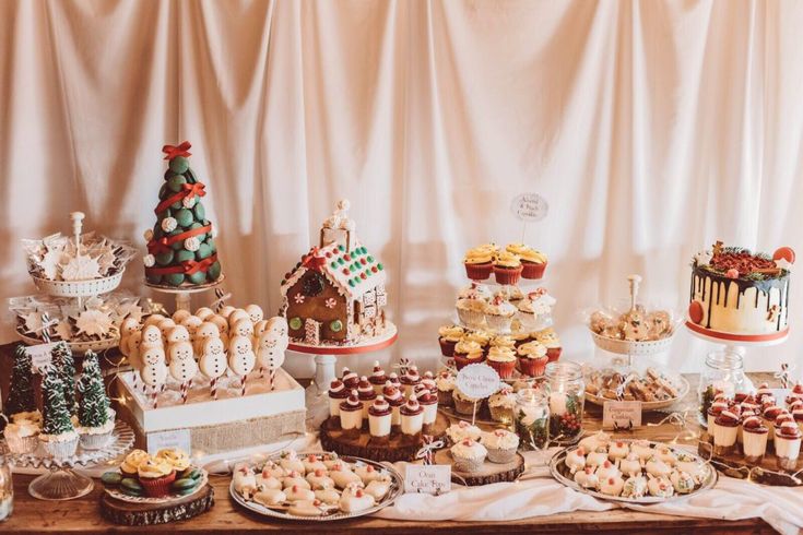 a table topped with lots of cakes and desserts