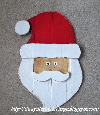 a wooden santa clause with eyes and a beard on the floor in front of carpet