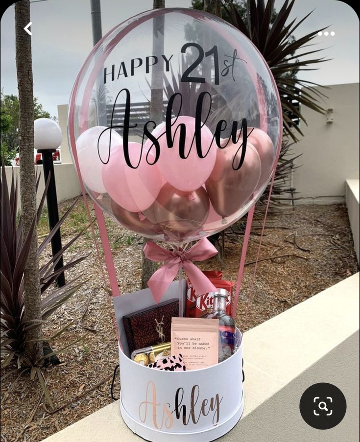 a birthday gift basket with balloons and confetti for someone's 21st birthday