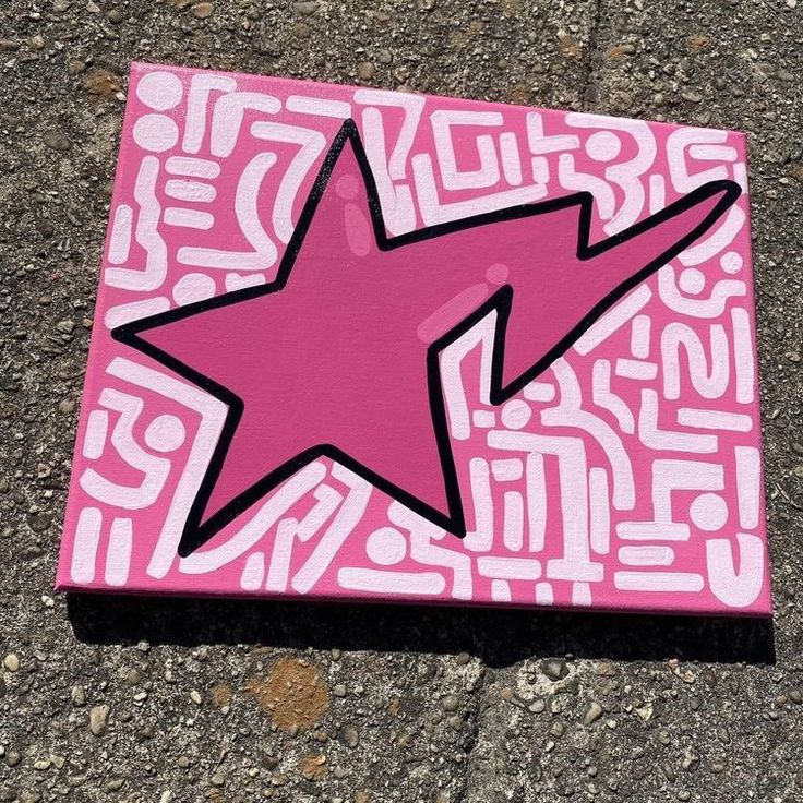 a pink and black star painted on the ground