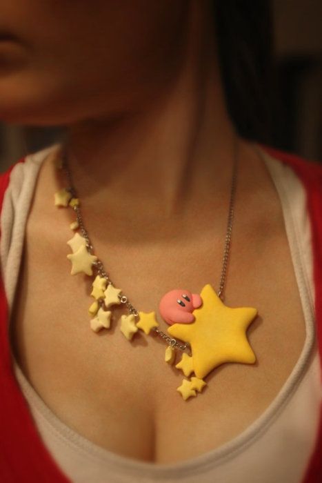 a woman wearing a necklace with stars and a star charm on it's neck