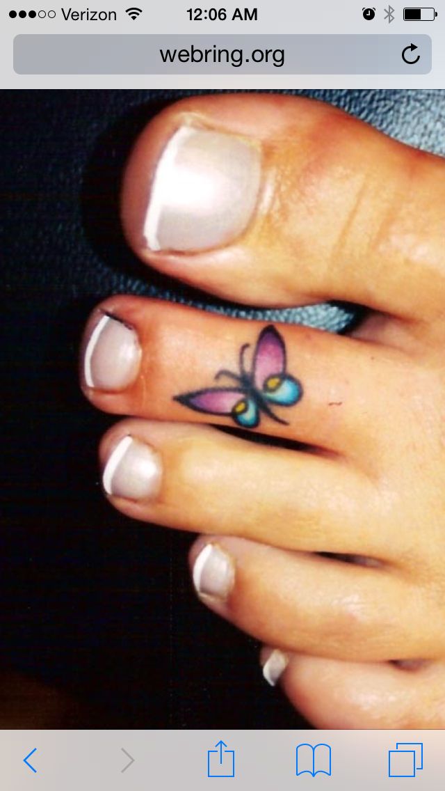 a woman's hand with a butterfly tattoo on her left thumb and the other finger