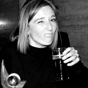 a black and white photo of a woman holding a wine glass in her right hand