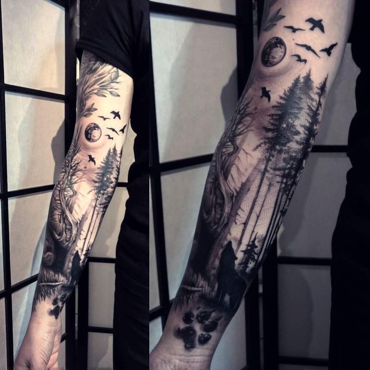 the arm is full of tattoos with animals and trees on it, while birds are flying around