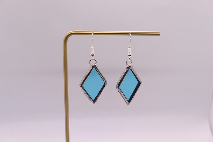 Hand made blue stained glass earrings with plated sterling silver hook. Perfect for a small holiday gift. Turquoise Jewelry With French Hook For Gift, Blue French Hook Jewelry As Gift, Turquoise Glass Earrings For Gift, Blue Glass Earrings For Gift, Purple Glass Dangle Earrings, Nickel-free Purple Glass Jewelry, Stained Glass Earrings, Blue Wire-wrapped Glass Earrings, Nickel-free Green Glass Earrings