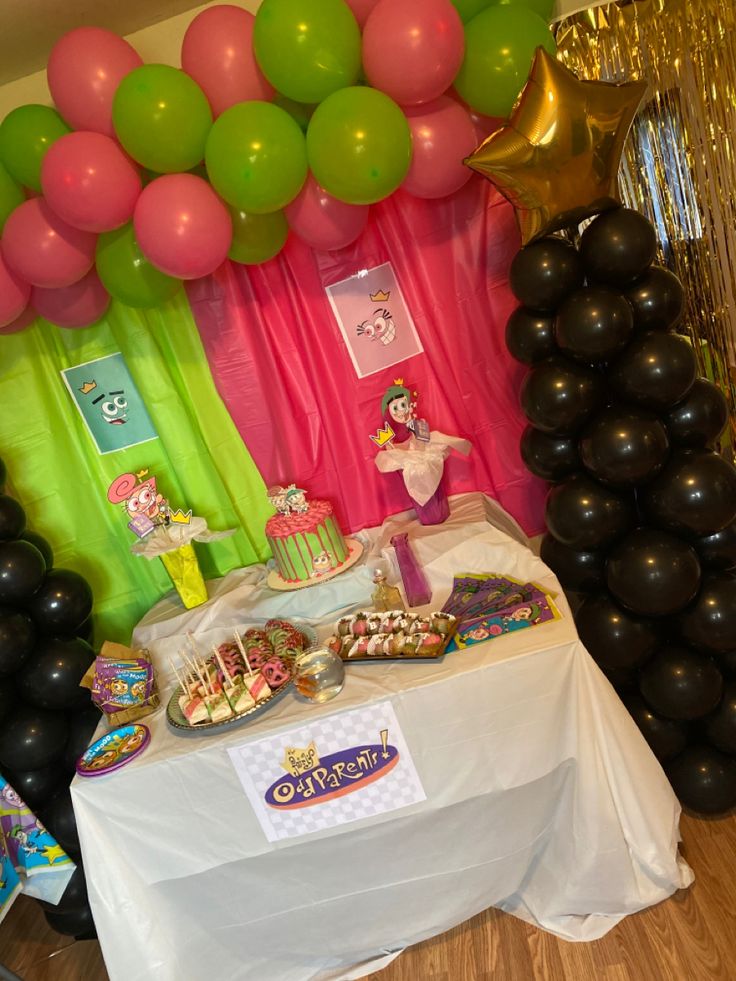 a table topped with lots of balloons and desserts