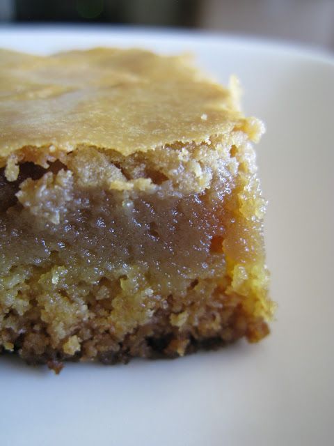 a close up of a piece of cake on a white plate with a blurry background