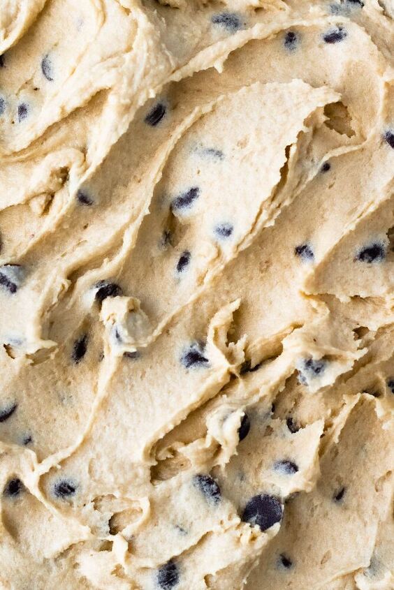 a close up view of a cookie dough with chocolate chips on top and the batter in the middle